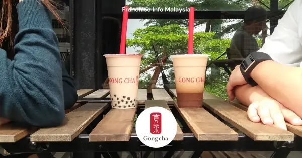 two person sitting in a table with two cups of Gongcha tea in front of them